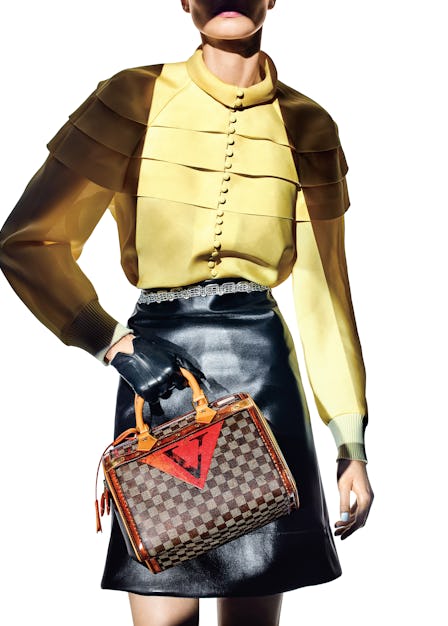 208LEGENDS OF THE FALLLouis Vuitton Speedy Time Trunk bag, blouse, belted skirt, and glove.