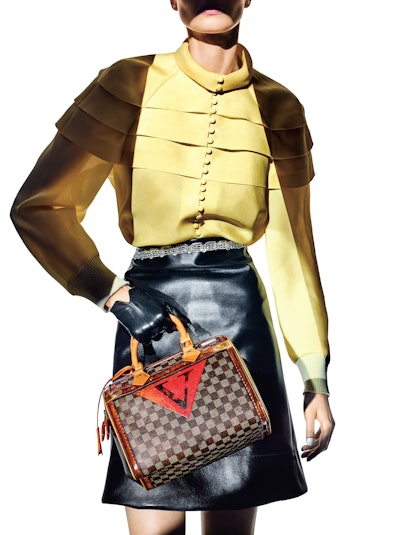 208LEGENDS OF THE FALLLouis Vuitton Speedy Time Trunk bag, blouse, belted skirt, and glove.