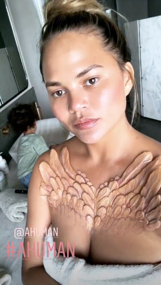 Chrissy Teigen with a piece from  A.Human collection on her collar bones resembling wings