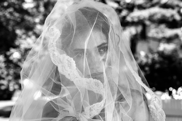 Imogen Poots wearing a white veil over her face