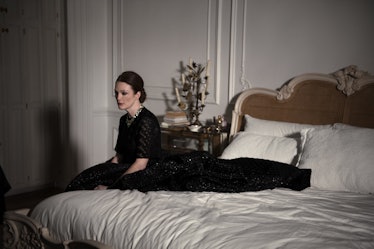 Julianne Moore sitting on her bed