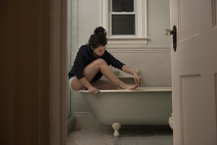 Tatiana Maslany cleaning her foot nails 