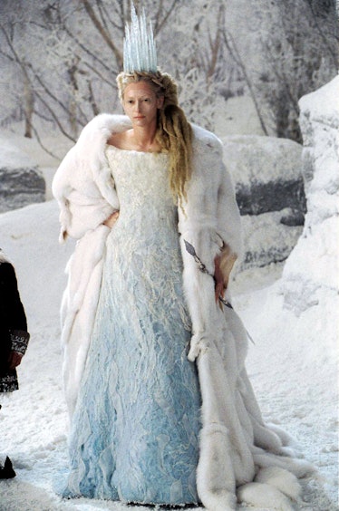 Tilda Swinton wearing a light blue dress and a furry coat portrayed as an Ice Witch