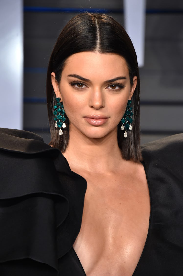 Kendall wearing her timeless slicked-back hairstyle complemented by a flawless makeup look at the Va...