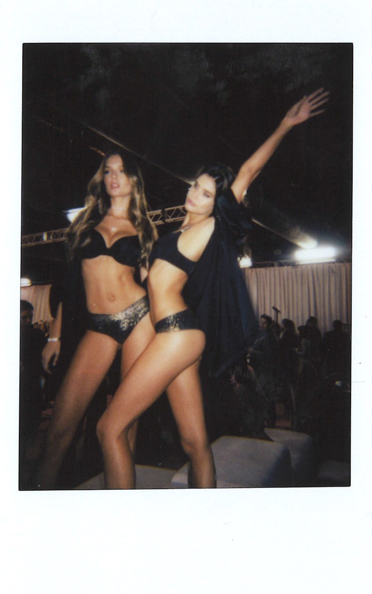 Josephine Skriver and Sara Sampaio backstage at the 2018 VSFS show posing in black bras and shimmery...
