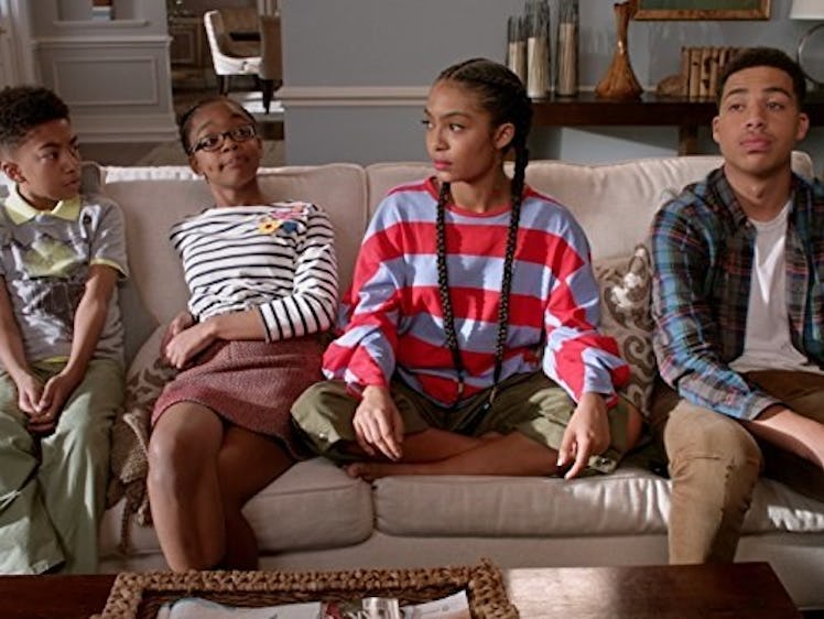 four kids sitting together on the couch