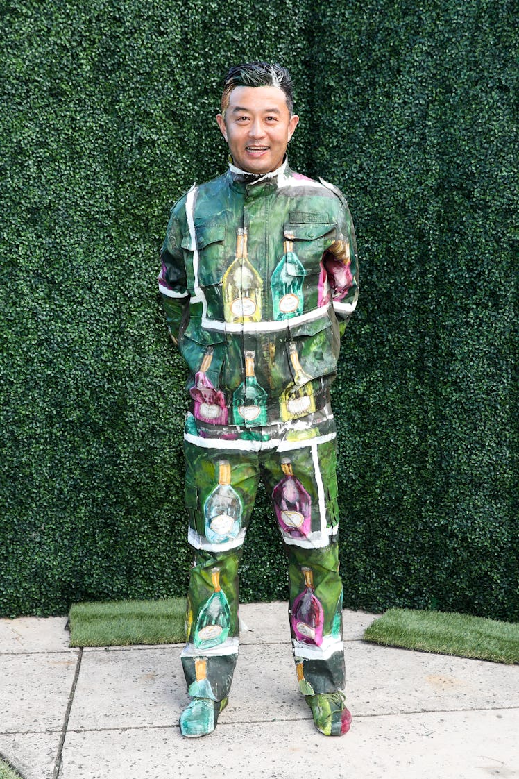 Liu Bolin posing in a tracksuit with bottles drawn on it