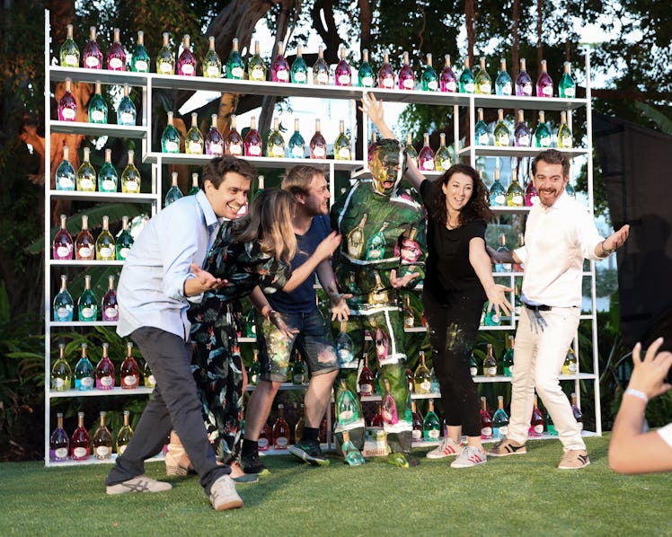 Liu Bolin posing for a photo with his staff while laughing