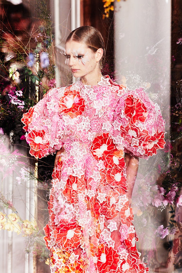 A model wearing a pink-and-orange floral gown at Valentino Haute Couture show in Paris