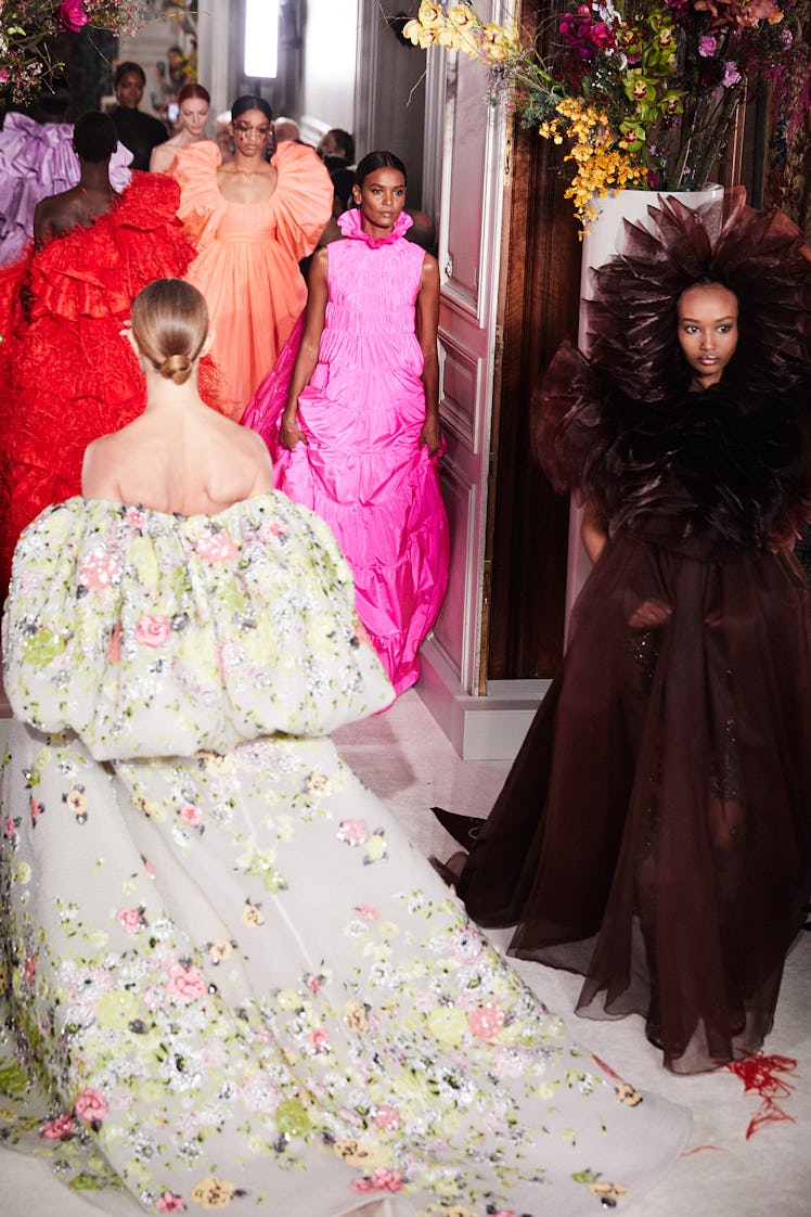 Models walking in colorful gowns during Valentino Haute Couture show in Paris