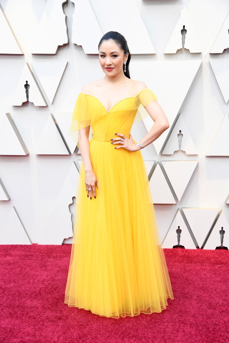 Constance Wu attending the 2019 Oscars Red carpet in a long yellow tulle dress