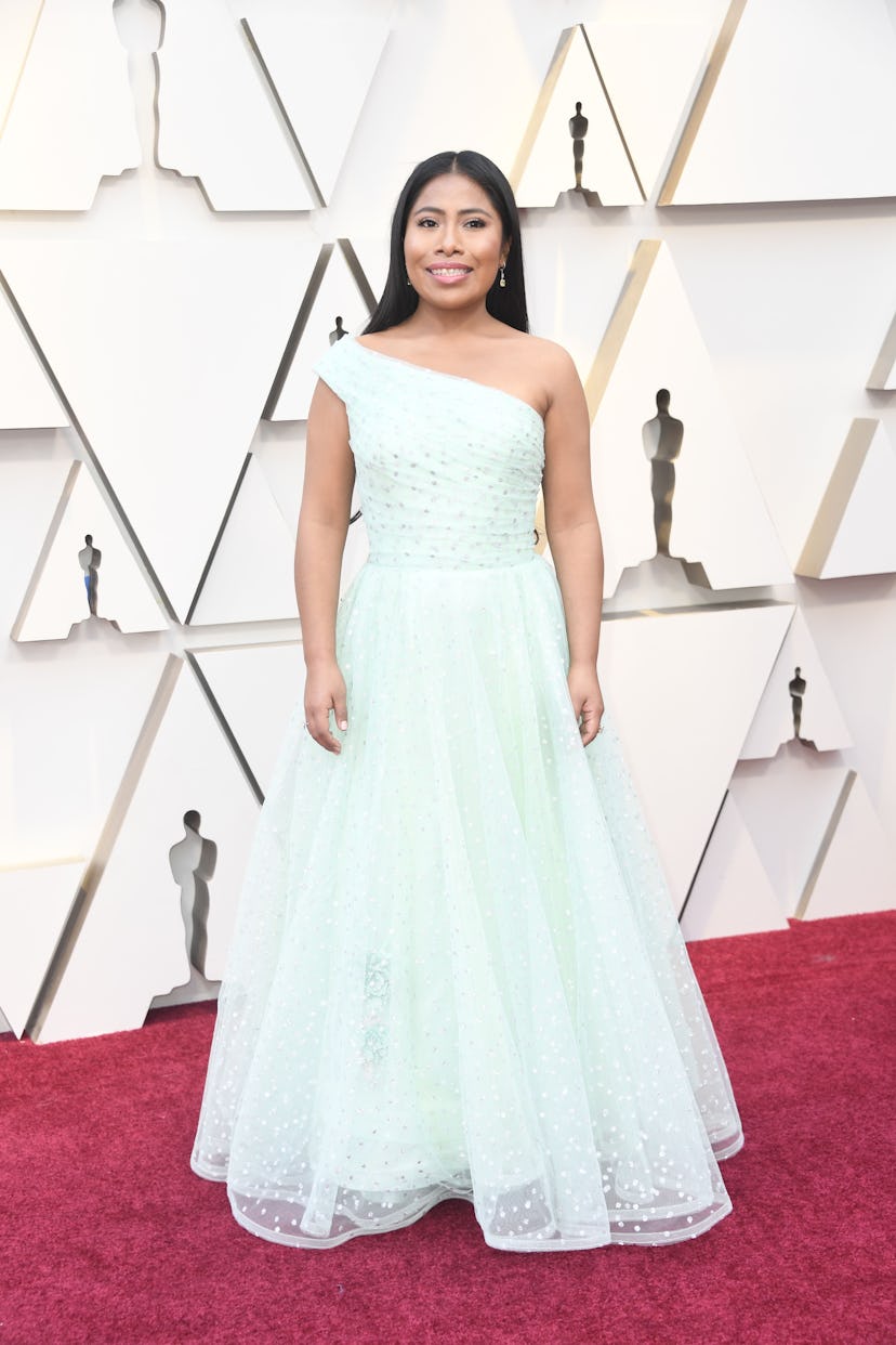 Yalitza Aparicio on the red carpet wearing a light blue dress at the 2019 Oscars