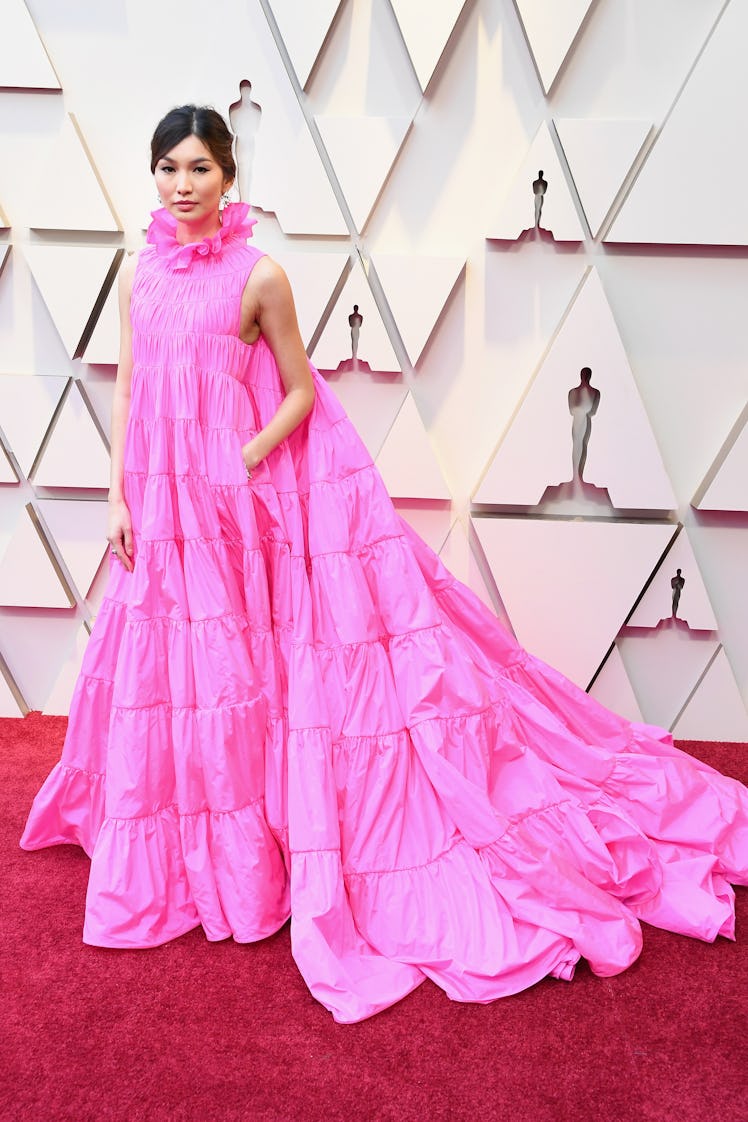 Gemma Chan posing in a long pink gown at the 2019 Oscars Red carpet 