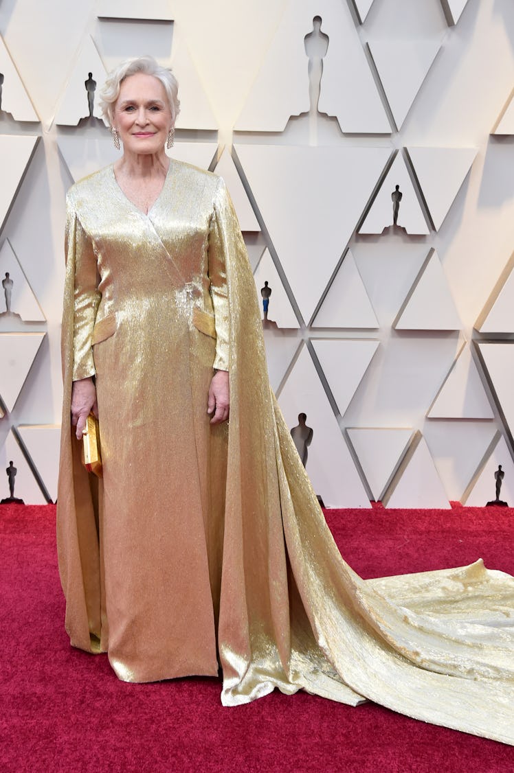 Glenn Close posing in a golden cape dress at the 2019 Oscars Red carpet 