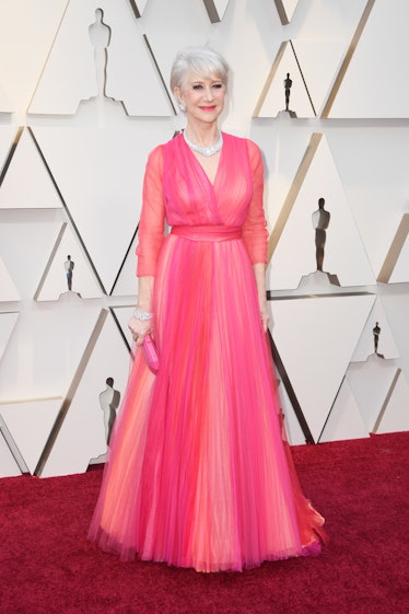 Dame Helen Mirren posing in a pink tulle dress while attending the 2019 Oscars Red carpet 