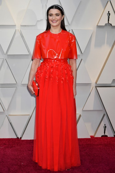 Rachel Weisz wearing an orange gown with a matching latex top while attending the 2019 Oscars Red ca...
