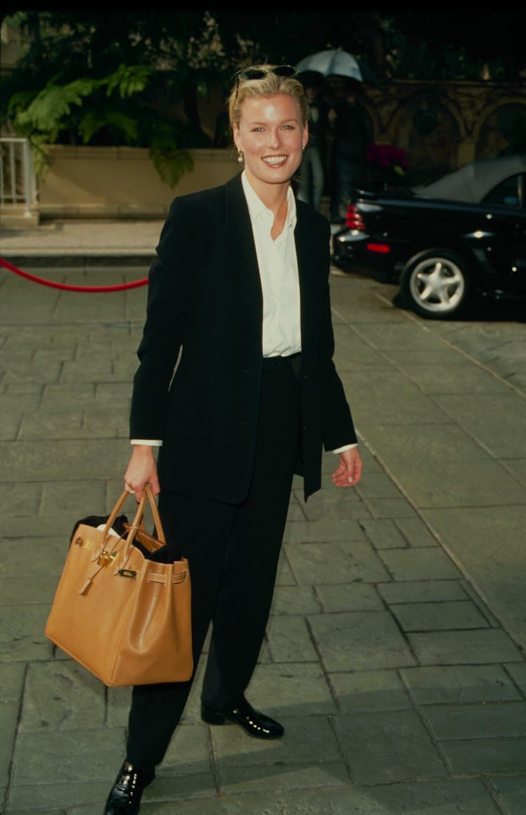 Vendela Kirsebom wearing a black suit with a white shirt smiling for a photo