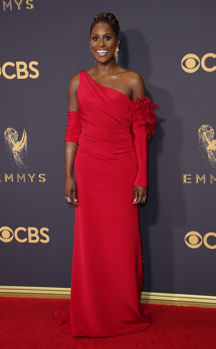 Issa in a long red gown with one shoulder exposed