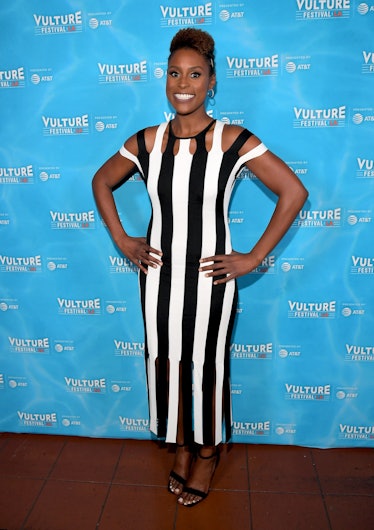 Issa wearing black and white vertical stripe dress