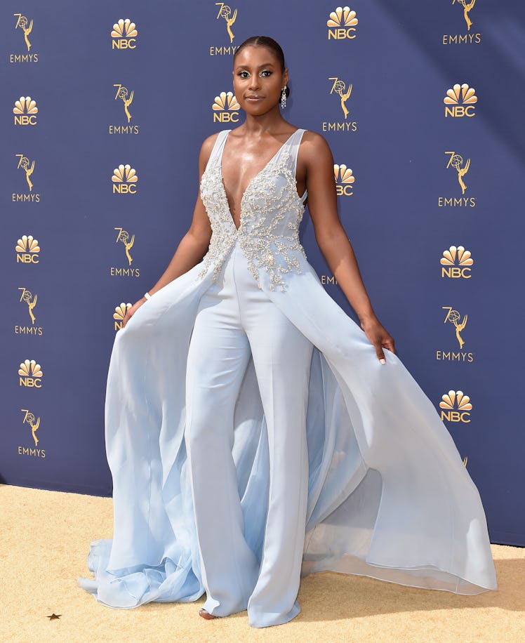 Issa wearing an icy blue jumpsuit with a train on the Emmy Awards' red carpet 