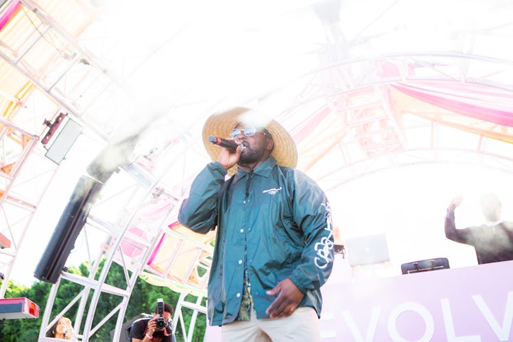 Schoolboy Q holding a microphone while performing at the Revolve Festival