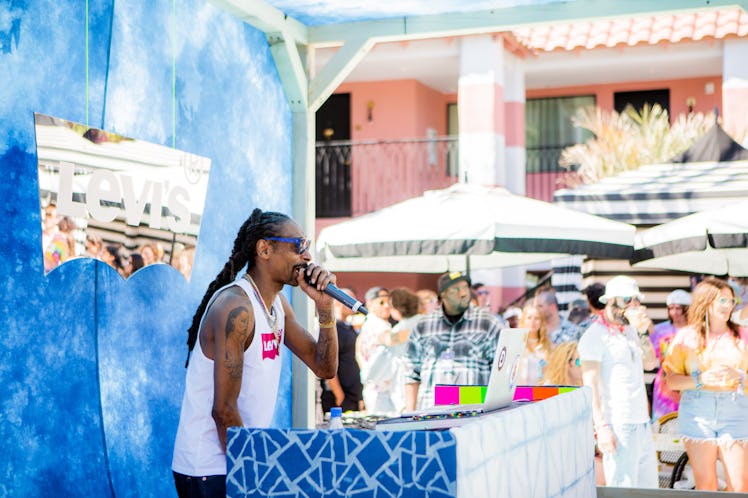 Snoop Dogg performing with a microphone at Levi’s Desert Party at the Sand Hotel and Spa