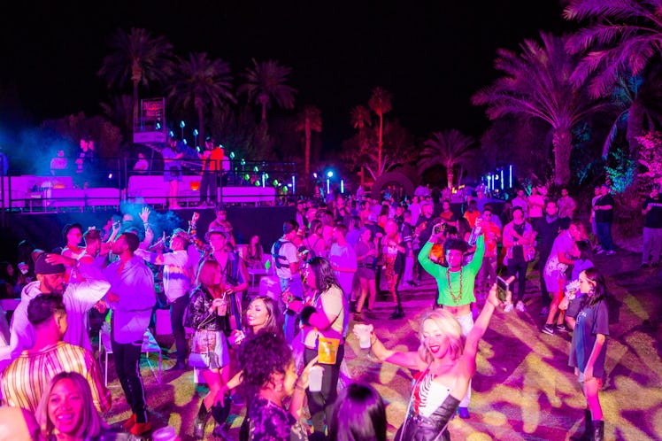 Guests dancing at night at the Moschino party in Indio, California