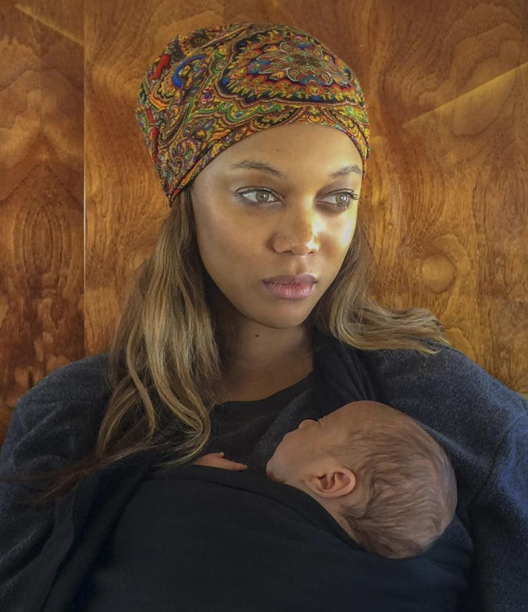 Actress and mom, supermodel Tyra Banks, holding her daughter in her arms.