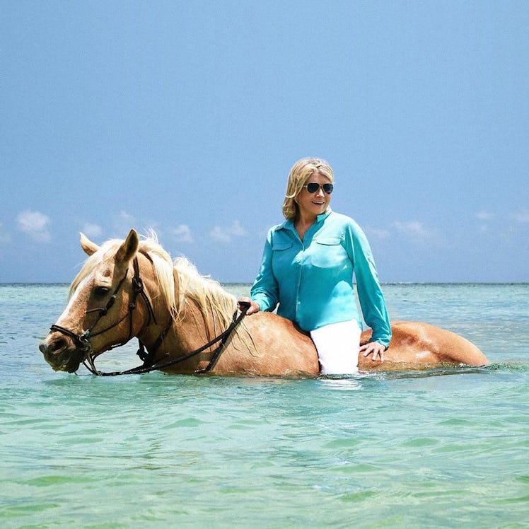 Martha Stewart riding a horse in the ocean