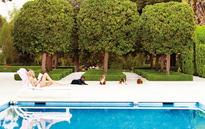 Sitting Pretty.Petra Ecclestone lounging poolside at her new palace.Omo Norma Kamali's stone-embelli...