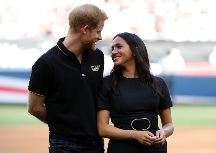 Meghan Markle and Prince Harry posing for a photo during Yankees-Red Sox baseball game