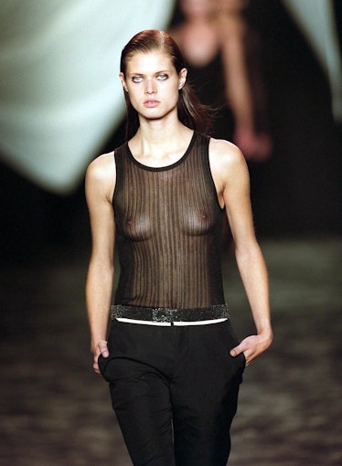 A model wears a see-through black mesh tank top ov