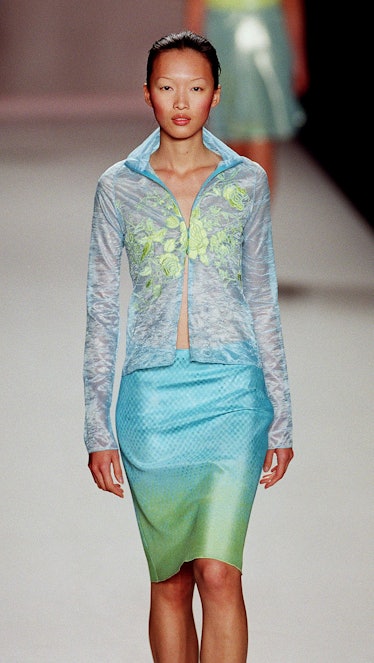 A model wears a print chiffon blouse over a turquo