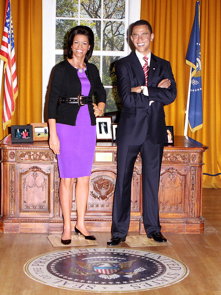 Michelle Obama and Barack Obama wax figures in the setting of The Oval Office at Madame Tussauds