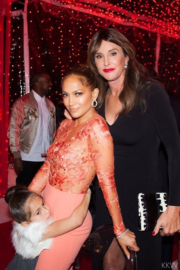 Jennifer Lopez and her daughter Emme, posing next to Caitlyn Jenner at a Christmas party