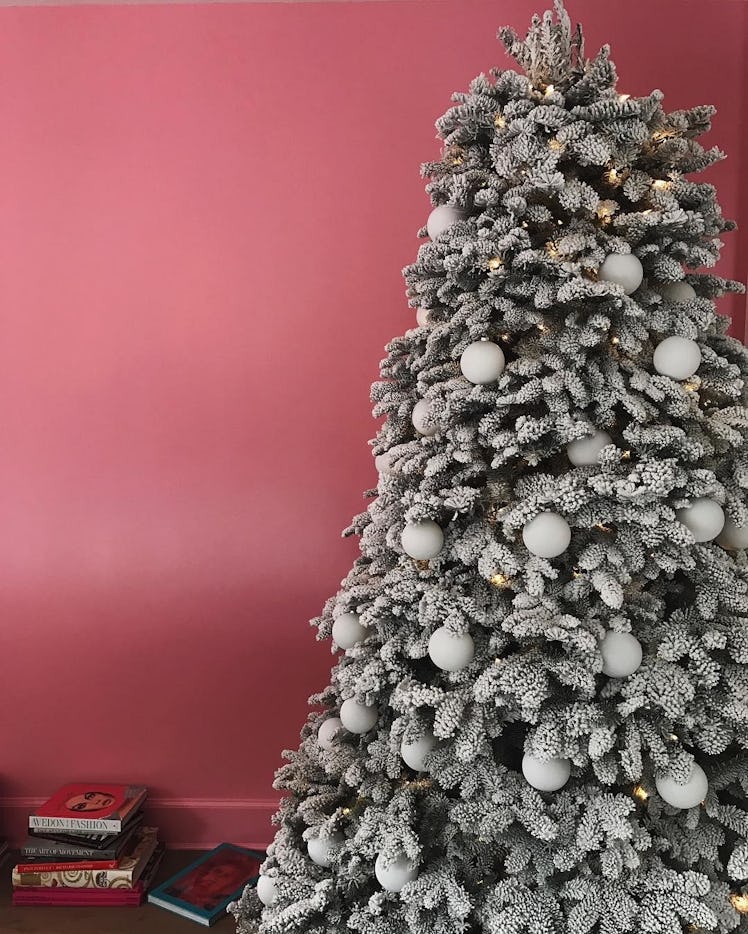 A Christmas tree with white ornaments next to a pink wall at Kendall Jenner's house