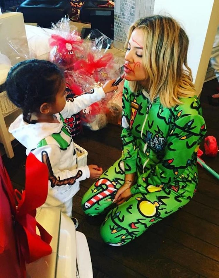 North West using red lipstick to draw over Khloe Kardashian's face during a Christmas party