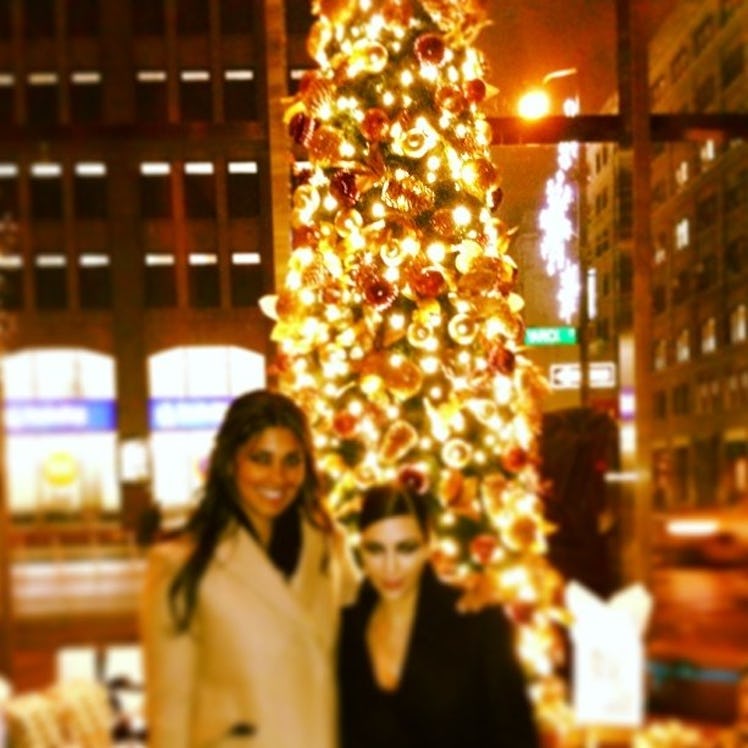 Rachel Roy and Kim Kardashian posing next to a Christmas Tree