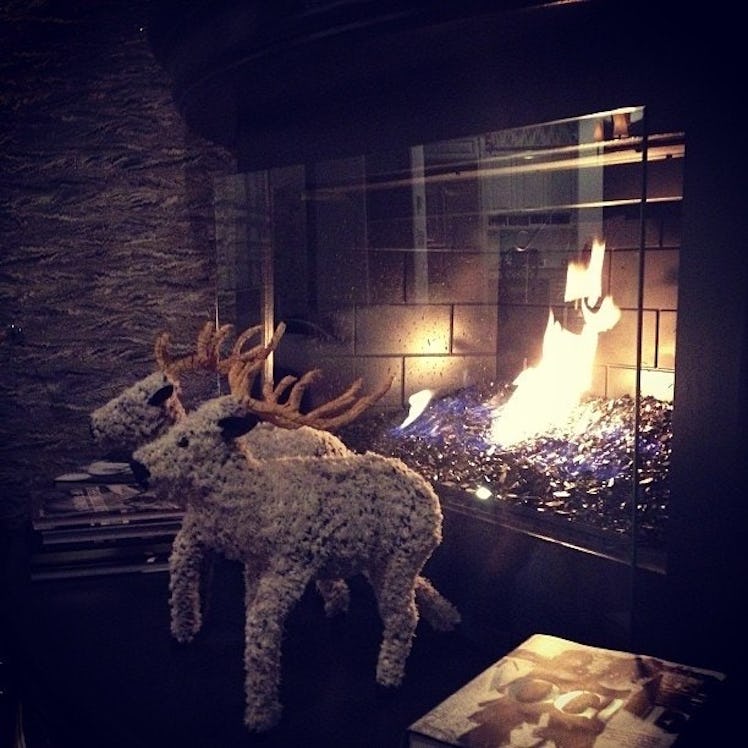 A fireplace and two Christmas deer decoration plushies in 2012 for a Kardashian Christmas celebratio...