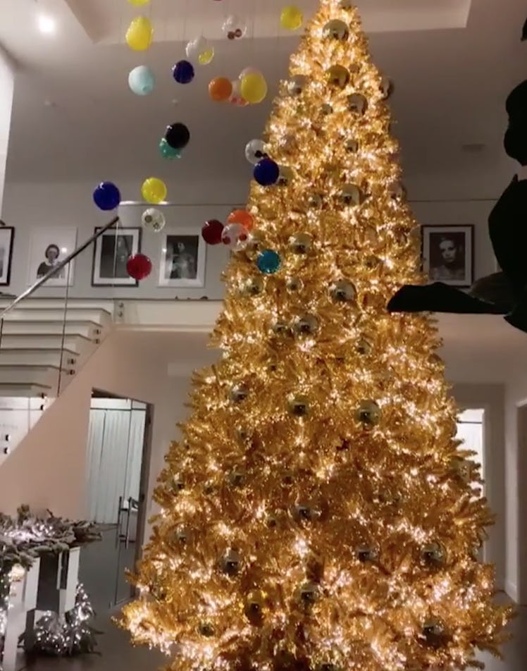 A large Christmas tree with golden ornaments at Kylie Jenner's house during Christmas