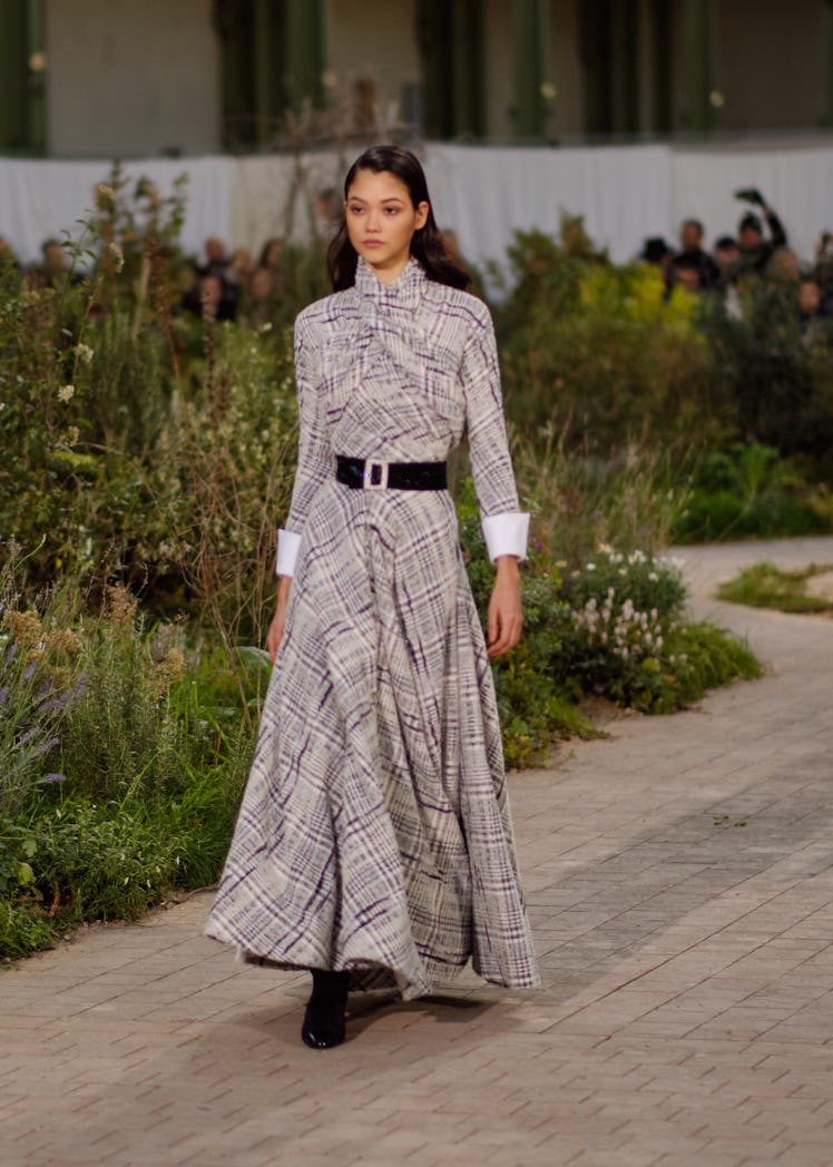 A model wearing a white-purple checked dress at the Chanel Couture Spring 2020 runway