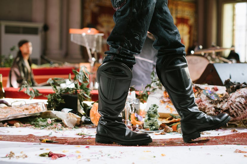 A man walking in black leather Telfar shoes