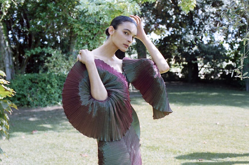 A model posing in a burgundy-black dress by Capucci Roma