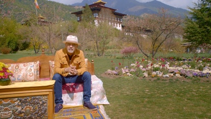 French shoe designer, Christian Louboutin sitting in a garden in Bhutan
