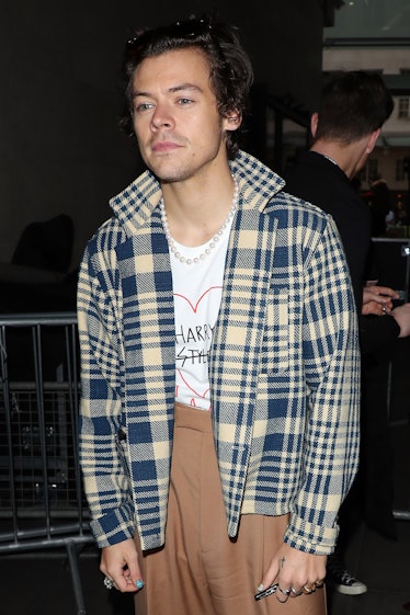 Harry Styles leaving BBC Radio One wearing flannel and pearls.