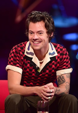 Harry Styles smiling and wearing pearls, during the filming for the Graham Norton Show at BBC Studio...