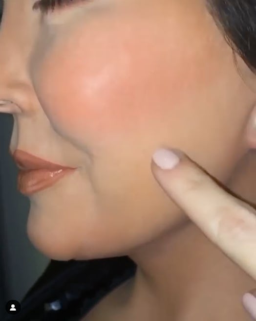 A finger over the Kris Jenner wax figure cheek