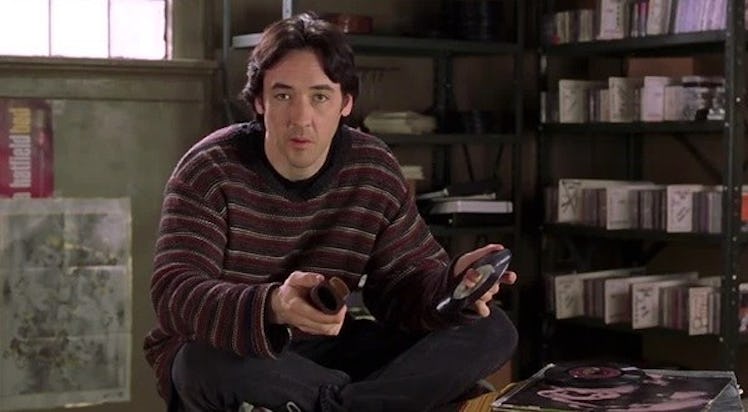 John Cusack wearing a baggy grandpa sweater in the original High Fidelity