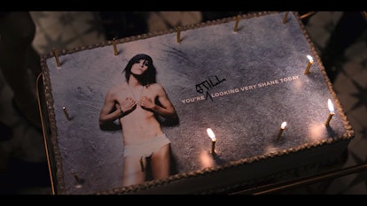 A birthday cake with "you're still looking very shane today" text and candles 