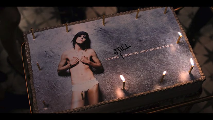 A birthday cake with "you're still looking very shane today" text and candles